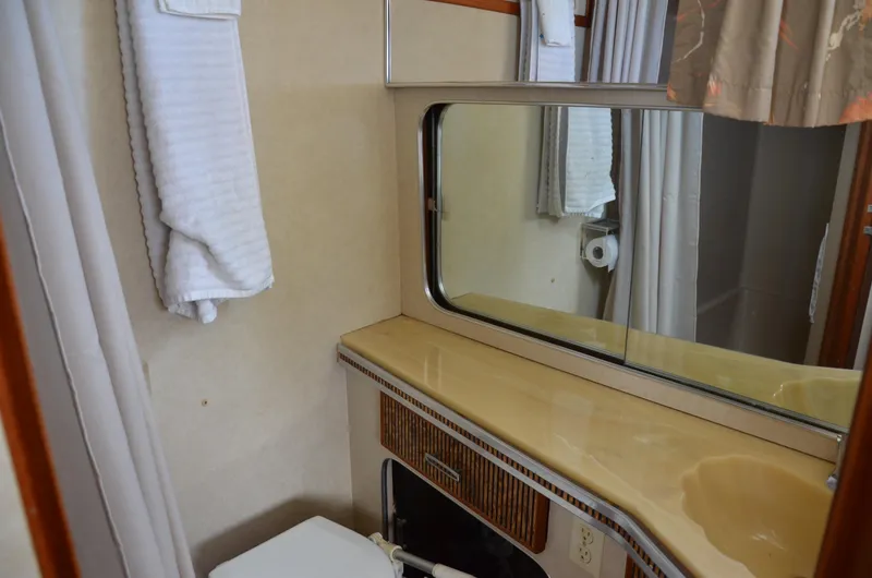 Slide: The Image of 1984 Chris-Craft 381 Catalina bathroom with mirror, sink, and towel. - 40