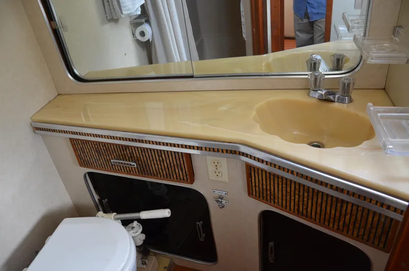 Slide: The Image of 1984 Chris-Craft 381 Catalina bathroom with sink, mirror, and toilet. - 41