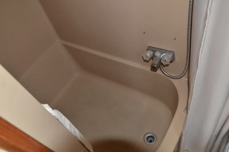 Slide: The Image of 1984 Chris-Craft 381 Catalina bathroom tub with faucet and drain. - 42