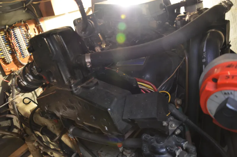 Slide: The Image of Engine compartment of a 1984 Chris-Craft 381 Catalina boat, showcasing mechanical components. - 47