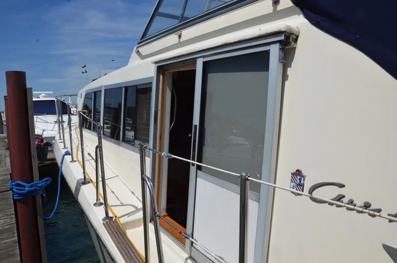 Slide: The Image of 1984 Chris-Craft 381 Catalina yacht docked, showcasing side view and sliding door. - 5