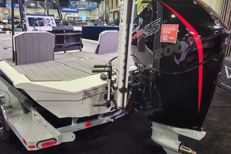 Slide: The Image of 2023 Vexus AVX2180CC boat with powerful outboard motor displayed at a boat show. - 11