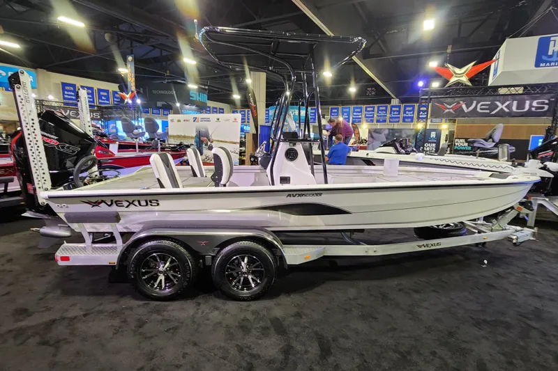 Slide: The Image of 2023 Vexus AVX2180CC boat on display at an indoor exhibition. - 13