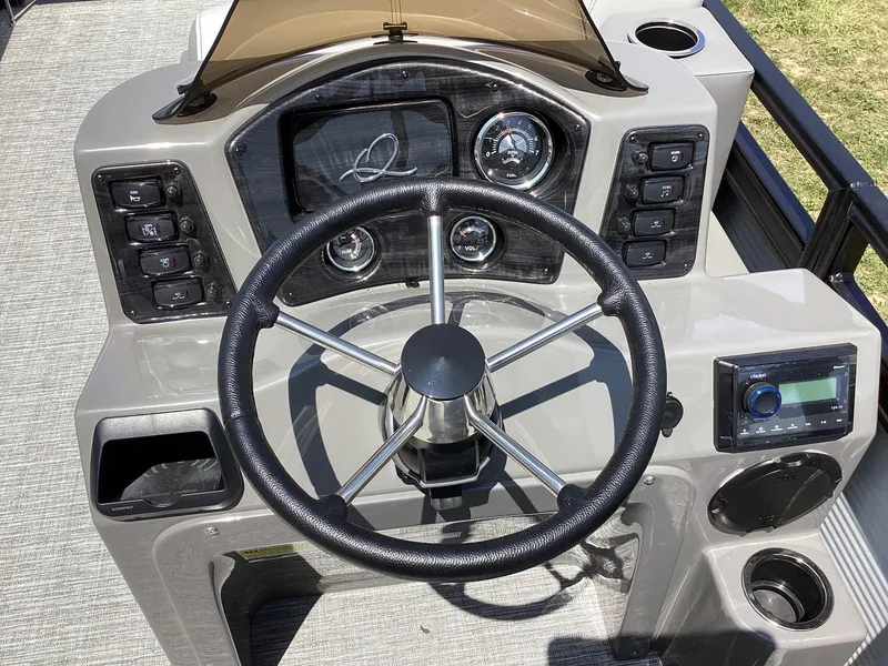 Slide: The Image of 2023 Qwest 820 Lanai L boat steering console with controls and gauges. - 8