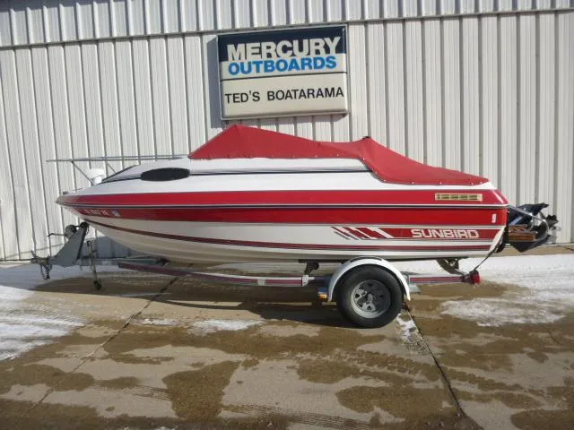 Slide: The Image of 1990 Sunbird CORSICA 188 Cuddy Cabin boat with red cover on trailer at Ted's Boatarama. - 0