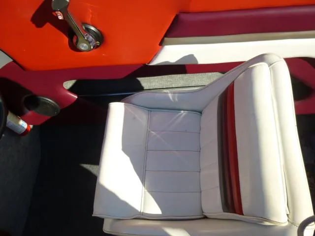 Slide: The Image of White and red seat in a 1990 Sunbird CORSICA 188 Cuddy Cabin boat. - 13