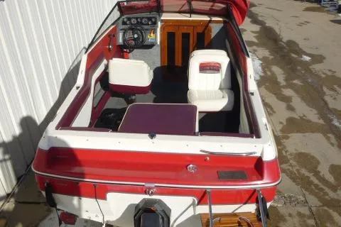 Slide: The Image of 1990 Sunbird CORSICA 188 Cuddy Cabin boat interior with red and white seating. - 18