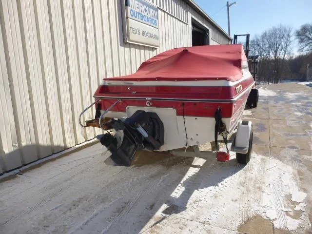 Slide: The Image of 1990 Sunbird CORSICA 188 Cuddy Cabin boat with red cover, parked outside Ted's Boatharbor. - 3