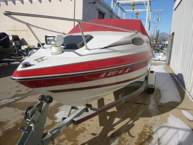 Slide: The Image of 1990 Sunbird CORSICA 188 Cuddy Cabin boat with red and white exterior on trailer. - 6