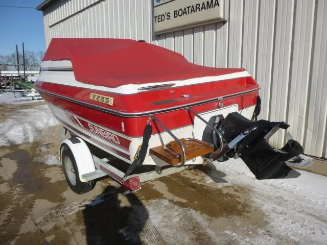 Slide: The Image of 1990 Sunbird CORSICA 188 Cuddy Cabin boat with red cover on trailer. - 7