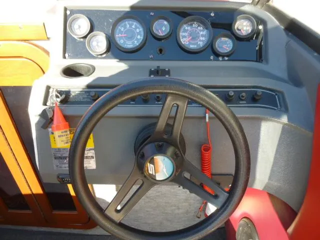 Slide: The Image of 1990 Sunbird CORSICA 188 Cuddy Cabin boat dashboard with steering wheel and gauges. - 9