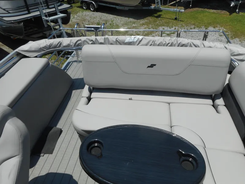 Slide: The Image of 2023 Starcraft CX 23 Q pontoon boat interior with seating and table. - 10