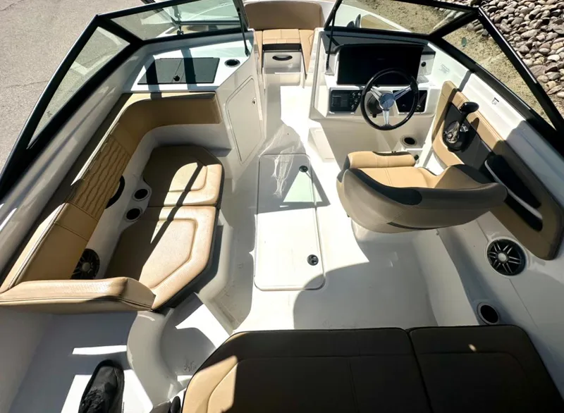 Slide: The Image of 2023 Sea Ray SPX 190 Outboard interior with tan seating and modern dashboard. - 13