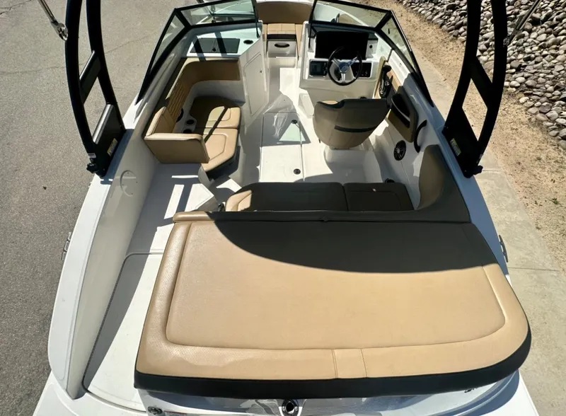 Slide: The Image of 2023 Sea Ray SPX 190 Outboard boat interior with tan seating and modern dashboard. - 14
