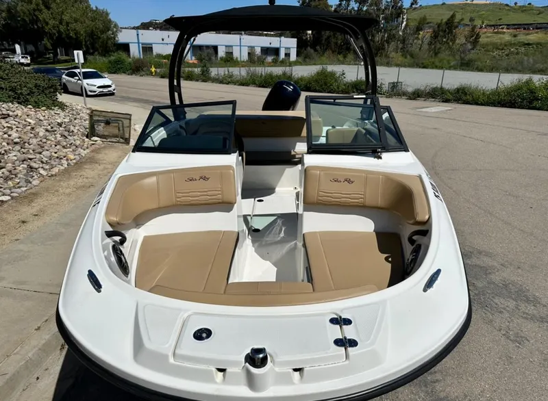 Slide: The Image of 2023 Sea Ray SPX 190 Outboard boat with tan seating, parked on a sunny day. - 4