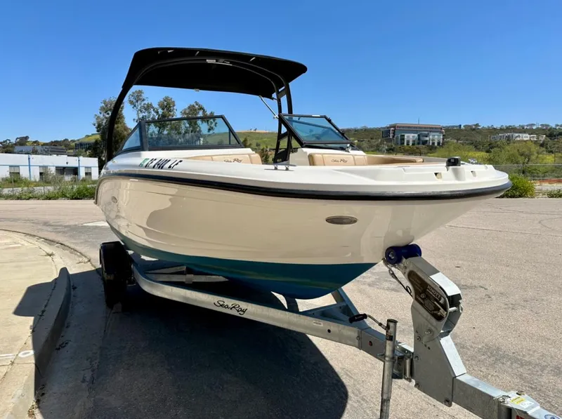Slide: The Image of 2023 Sea Ray SPX 190 Outboard boat on trailer, parked outdoors under clear sky. - 6