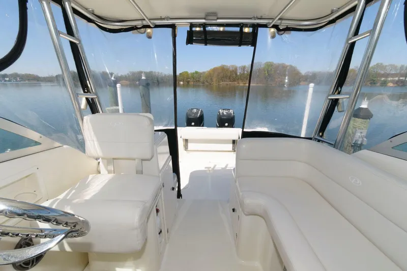 Slide: The Image of 2006 Pursuit 3070 Offshore boat interior with seating and lake view. - 11