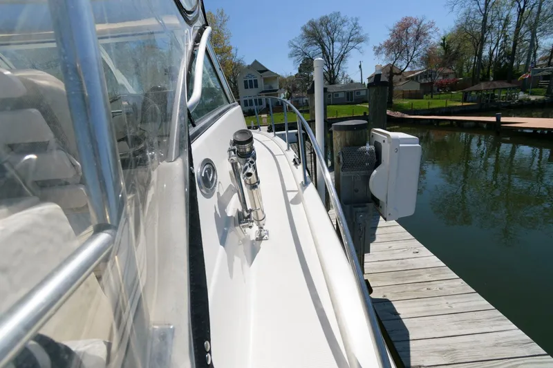 Slide: The Image of 2006 Pursuit 3070 Offshore boat docked at a marina. - 12