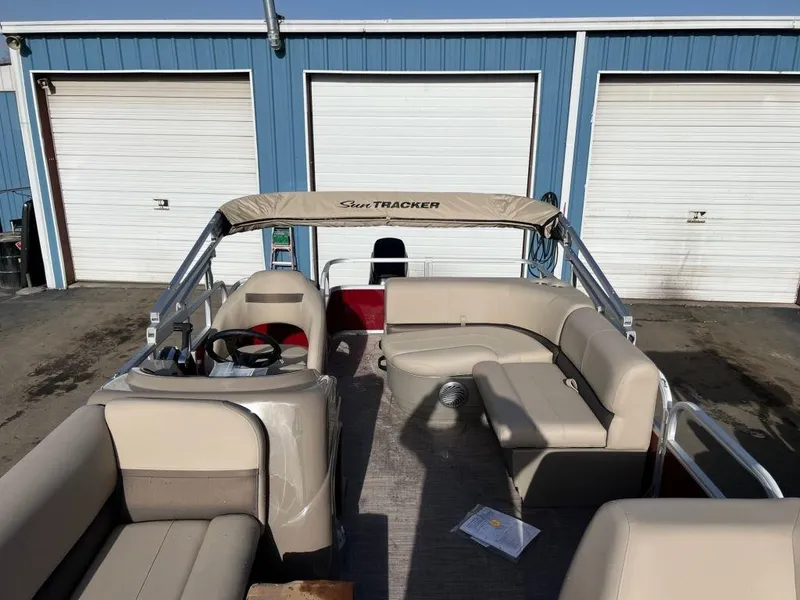 Slide: The Image of 2023 Sun Tracker PARTY BARGE® 18 DLX pontoon boat with beige seating and canopy. - 2