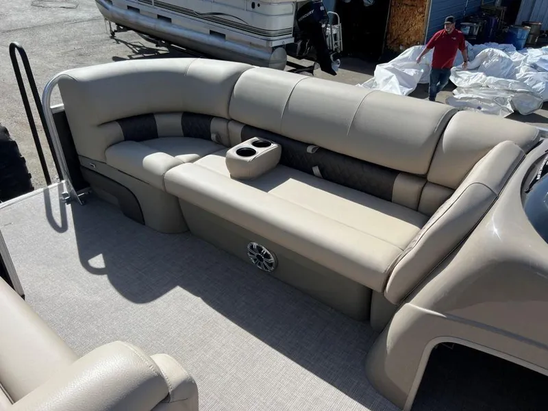 Slide: The Image of 2023 Sun Tracker PARTY BARGE® 20 DLX pontoon boat interior with beige seating and cup holders. - 5
