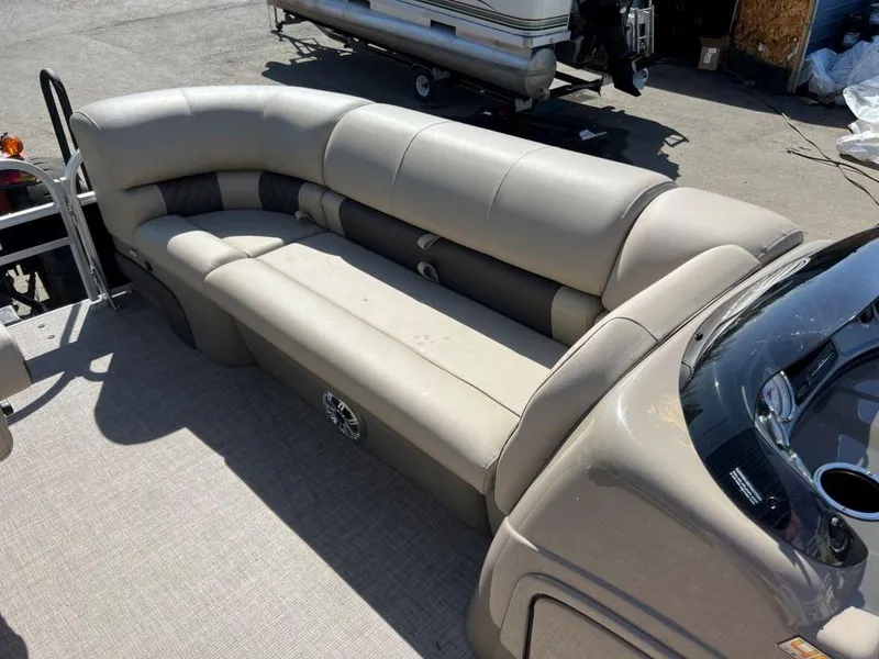 Slide: The Image of 2023 Sun Tracker Sportfish™ 20 DLX pontoon boat with beige seating and spacious deck. - 3