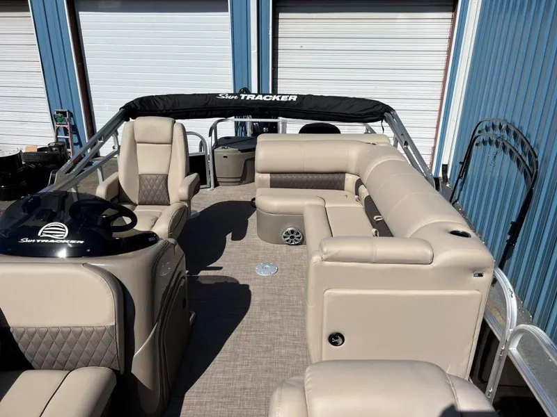 Slide: The Image of 2023 Sun Tracker Sportfish™ 20 DLX pontoon boat with beige seating and black canopy. - 4