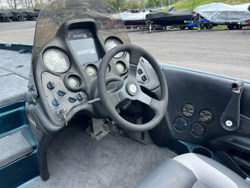 Slide: The Image of 2000 Stratos 20ss boat dashboard with steering wheel and instrument panel. - 3