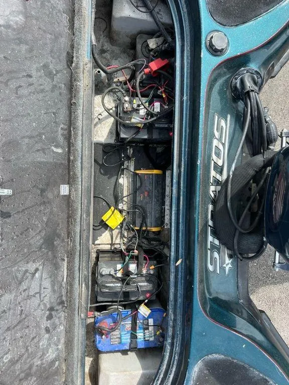 Slide: The Image of Battery compartment of a 2000 Stratos 20ss boat with visible wiring. - 4