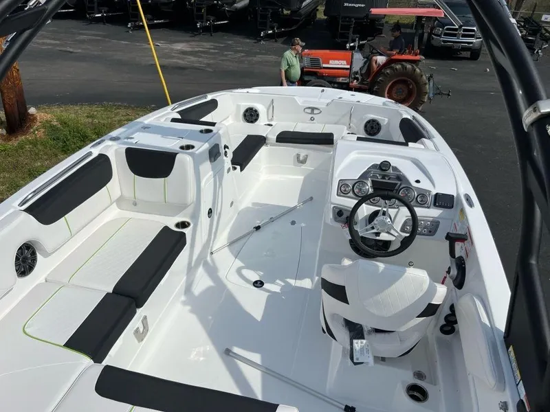 Slide: The Image of 2023 Tahoe 2150 boat interior with black and white seating, steering console, and dashboard. - 3