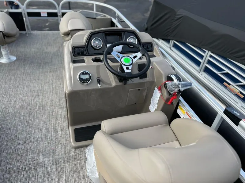 Slide: The Image of 2023 Ranger 200F boat interior with steering console and beige seating. - 10