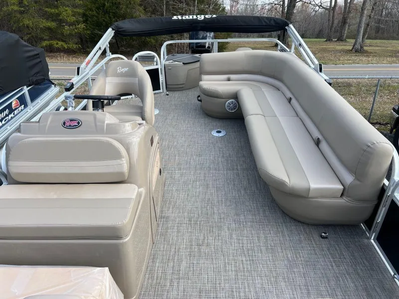 Slide: The Image of 2023 Ranger 200F pontoon boat with beige seating and spacious deck. - 11
