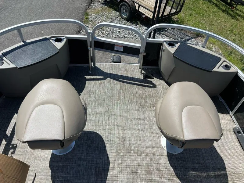 Slide: The Image of 2023 Ranger 200F boat with dual swivel seats and storage compartments. - 9