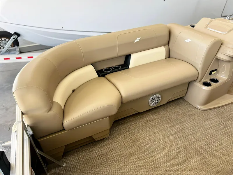 Slide: The Image of 2023 Starcraft LX 22 R boat interior with beige seating and cup holders. - 10