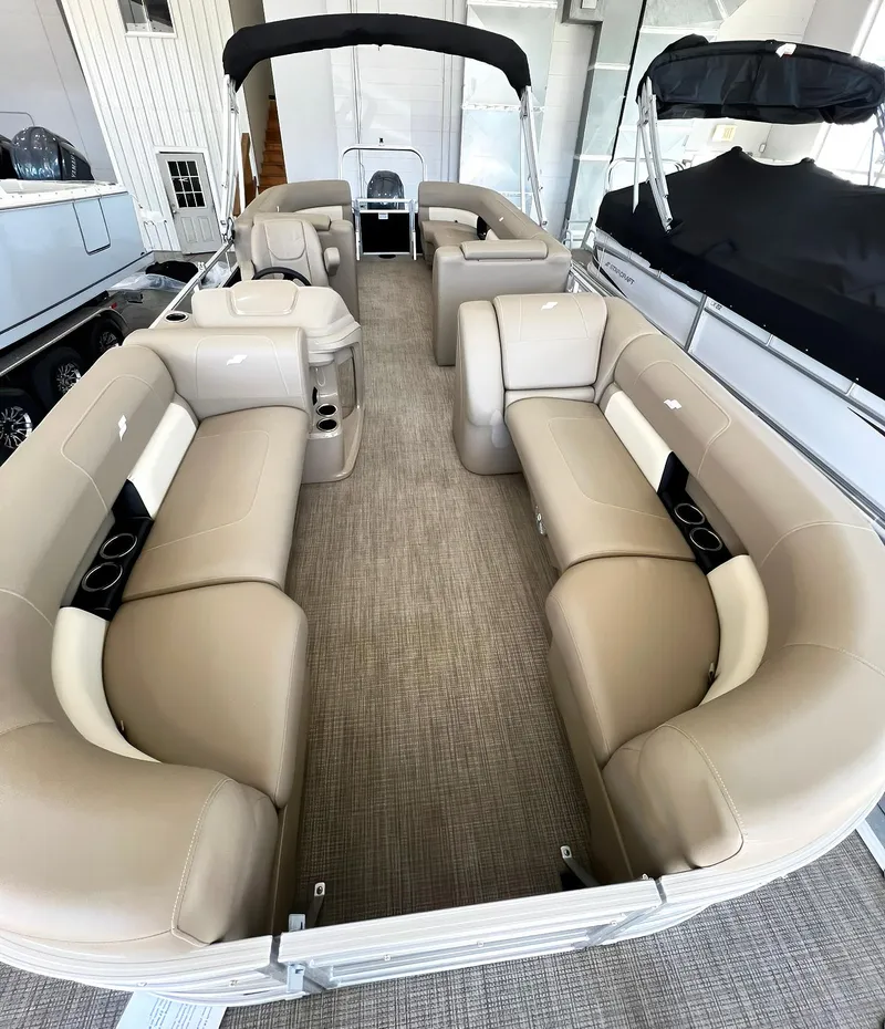Slide: The Image of 2023 Starcraft LX 22 R pontoon boat with spacious beige seating and modern design. - 11