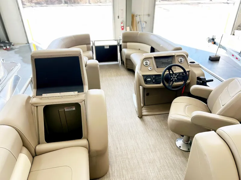 Slide: The Image of 2023 Starcraft LX 22 R boat interior with beige seating and modern dashboard. - 12