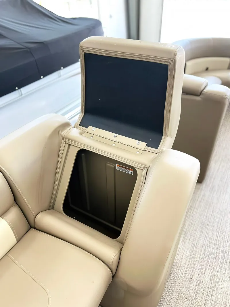 Slide: The Image of 2023 Starcraft LX 22 R boat interior with open storage compartment. - 15