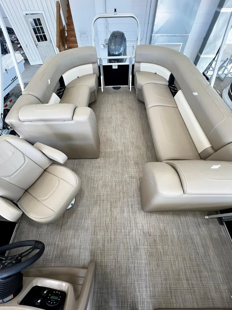 Slide: The Image of 2023 Starcraft LX 22 R pontoon boat interior with beige seating and modern design. - 16