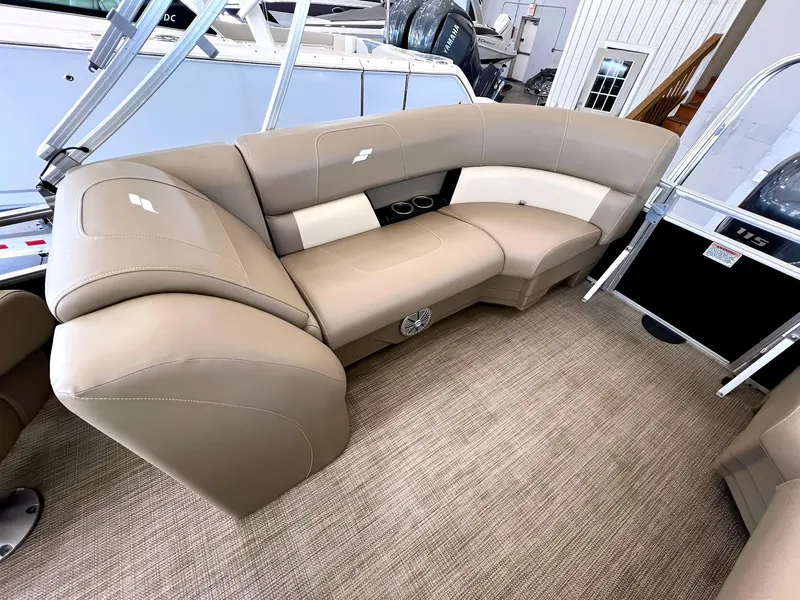 Slide: The Image of 2023 Starcraft LX 22 R boat interior with beige seating and carpeted flooring. - 18
