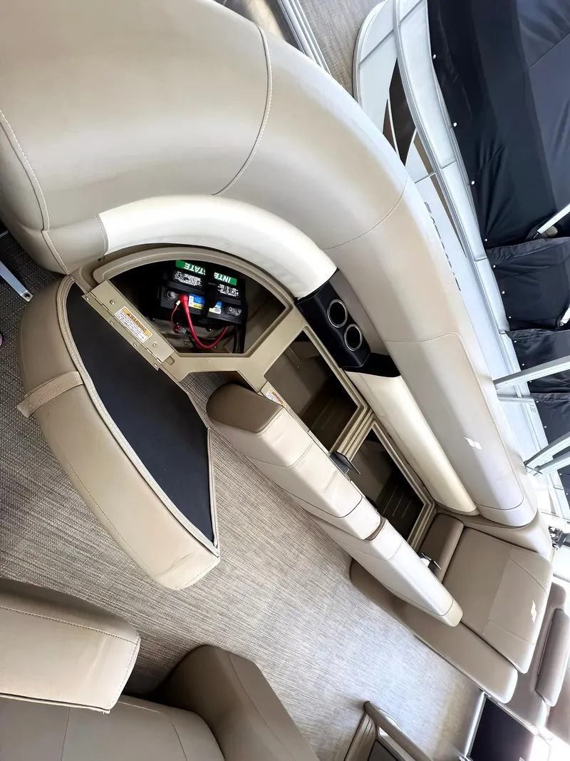 Slide: The Image of 2023 Starcraft LX 22 R boat interior with beige seating and storage compartments. - 20