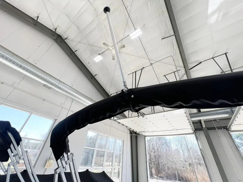 Slide: The Image of 2023 Starcraft LX 22 R boat canopy in a bright indoor setting. - 23