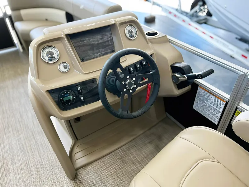 Slide: The Image of 2023 Starcraft LX 22 R boat dashboard with steering wheel and controls. - 3