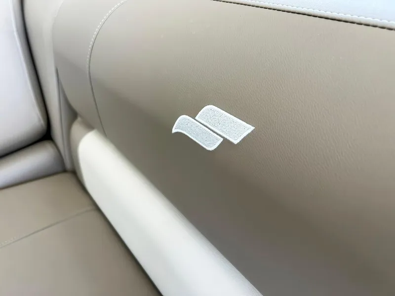 Slide: The Image of 2023 Starcraft LX 22 R interior, beige upholstery with logo detail. - 4