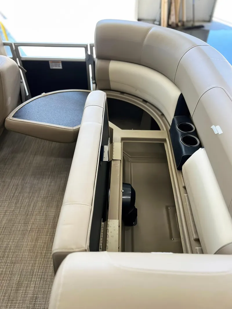 Slide: The Image of 2023 Starcraft LX 22 R boat interior with beige seating and storage compartment. - 5
