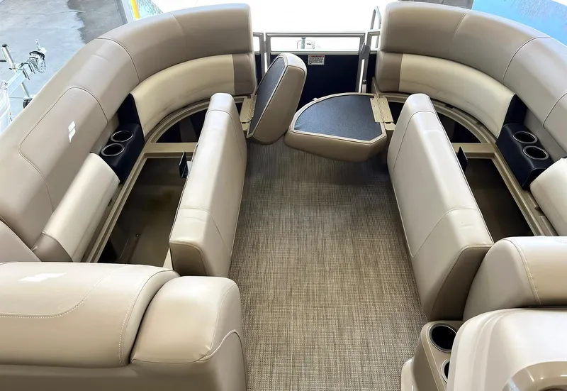 Slide: The Image of 2023 Starcraft LX 22 R pontoon boat interior with beige seating and cup holders. - 6