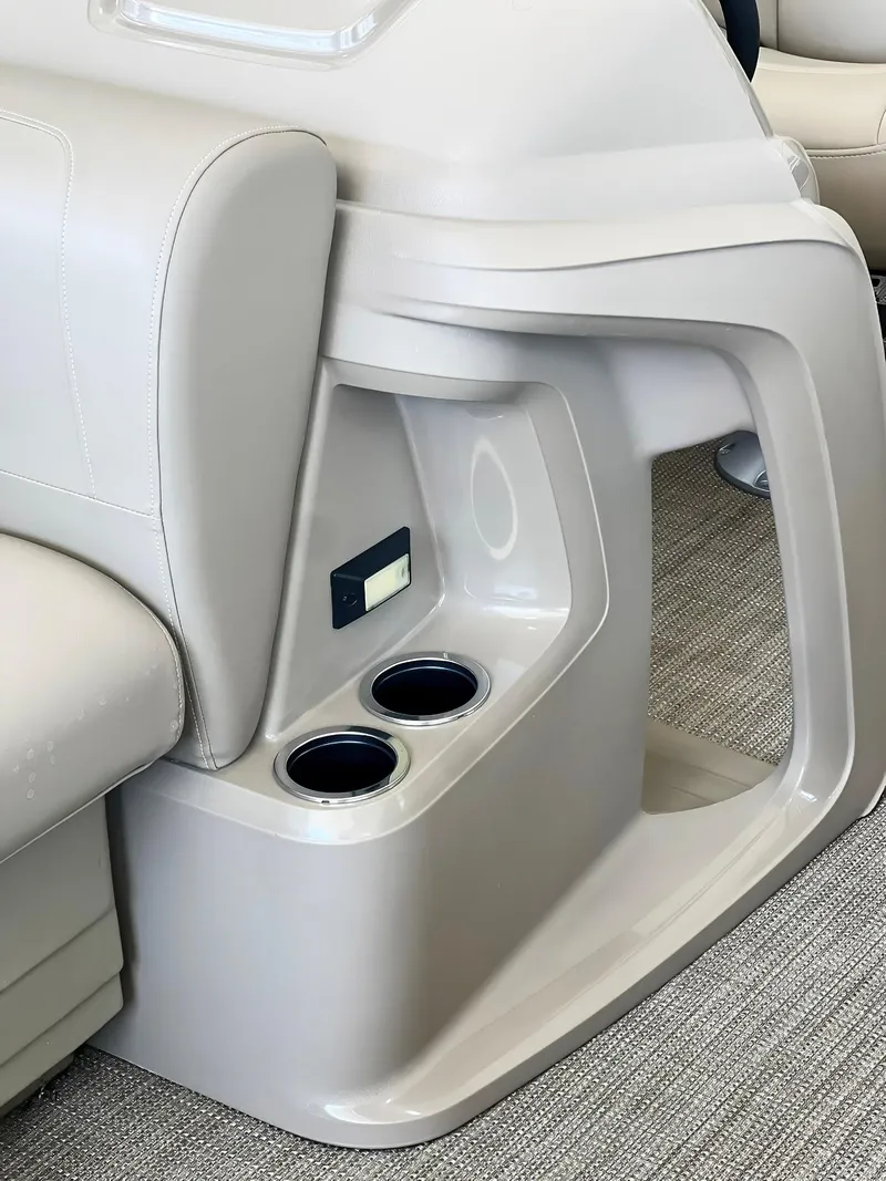 Slide: The Image of 2023 Starcraft LX 22 R boat interior with cup holders and seating. - 9