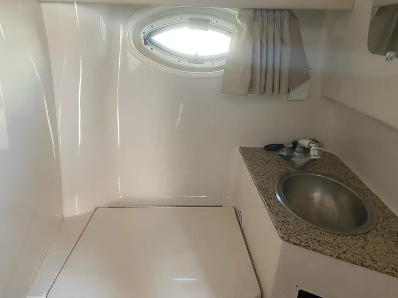 Slide: The Image of 2007 Monterey 290 Cruiser interior with sink and porthole window. - 4