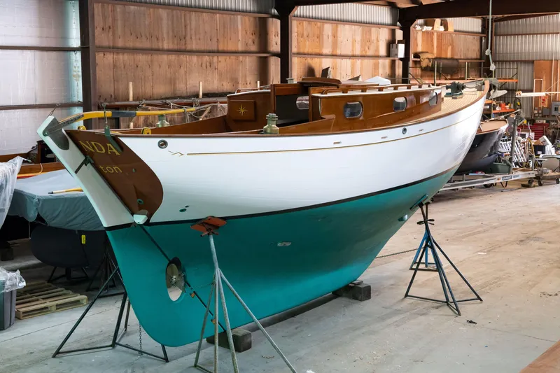 Slide: The Image of Custom 2008 Frank Paine Sloop in a workshop, showcasing classic design and craftsmanship. - 12
