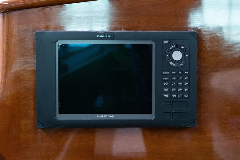 Slide: The Image of Simrad CX44 marine navigation system on 2008 Frank Paine Sloop's wooden dashboard. - 20