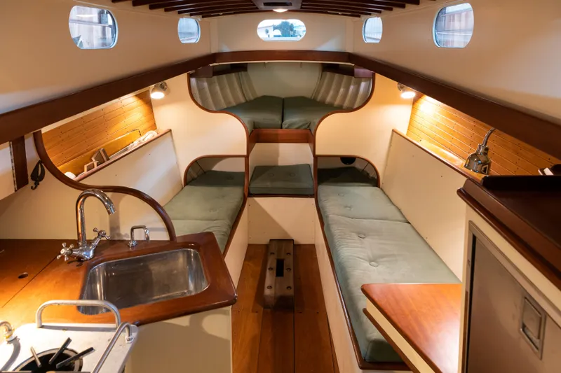 Slide: The Image of Interior of 2008 Custom Frank Paine Sloop with cozy seating and wooden finishes. - 21