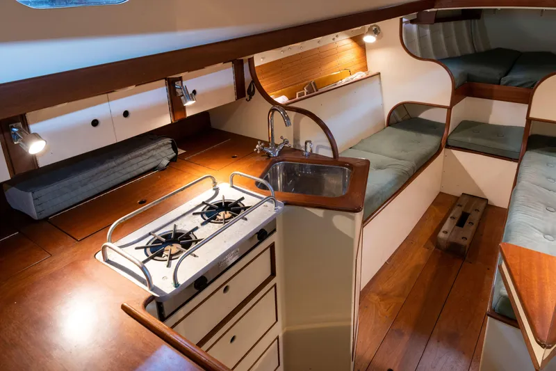 Slide: The Image of Interior of 2008 Custom Frank Paine Sloop with kitchen, sink, and cozy seating area. - 22